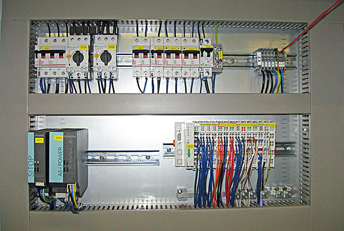 Inside view of a control cabinet with PLC for automation