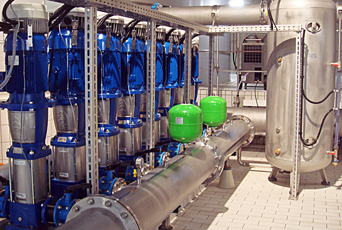 Pressure booster system with vertical pumps