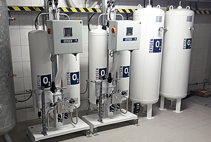 Oxygen generator with storage tanks